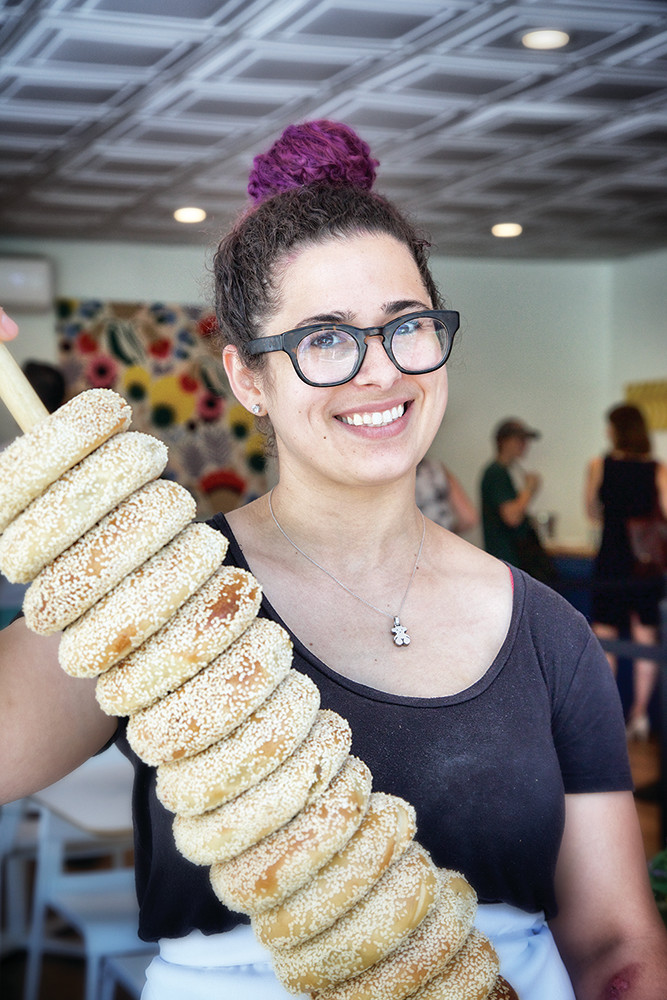 Milena Pagan, owner of Rebelle Artisan Bagels, cleverly uses poles to hold bagels